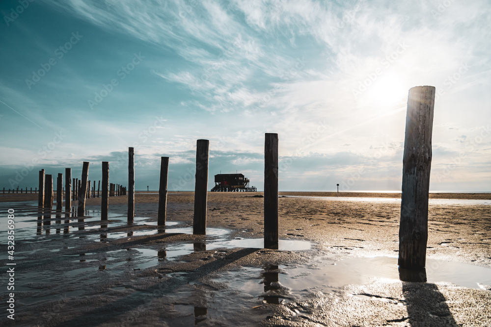 Stilt house on the beach of Sankt Peter-Ording in the sunset