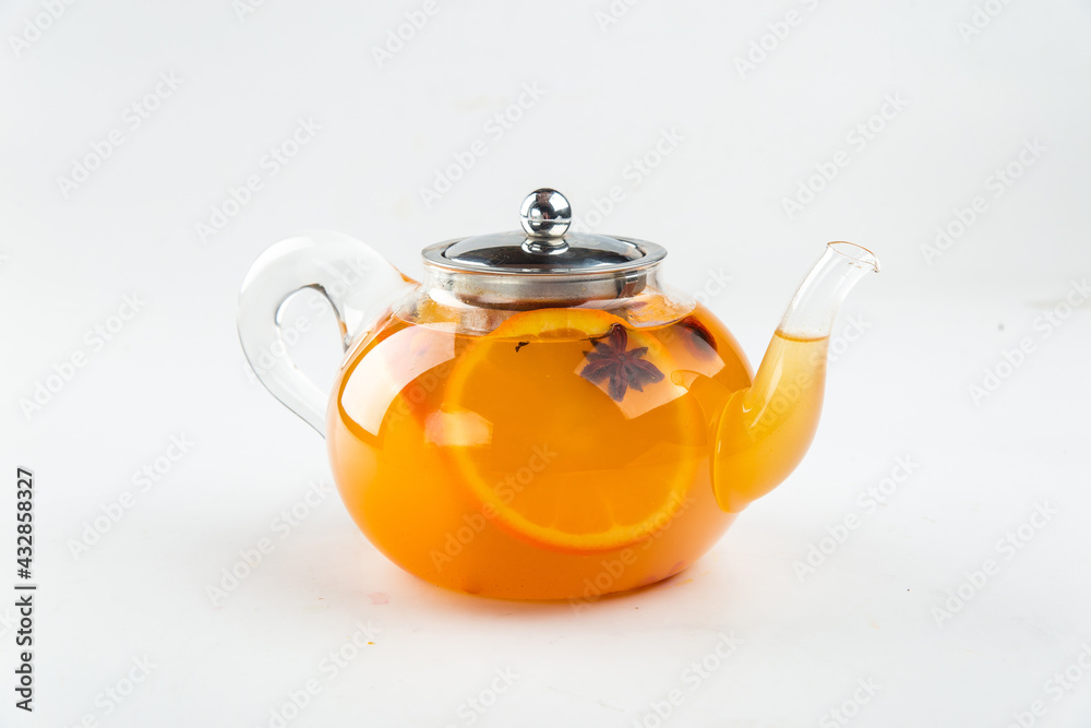 Isolated teapot of citrus tea with orange and anise on the white background Isolated teapot of citrus tea with orange and anise on the white background
