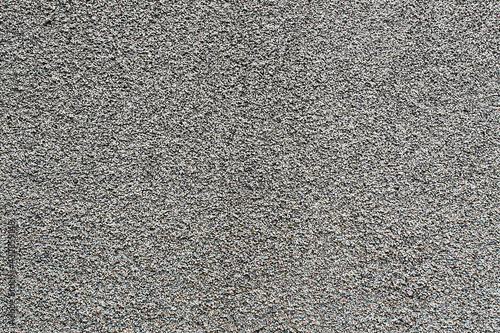 Abstract texture uneven grungy gray wall with very small pebbles