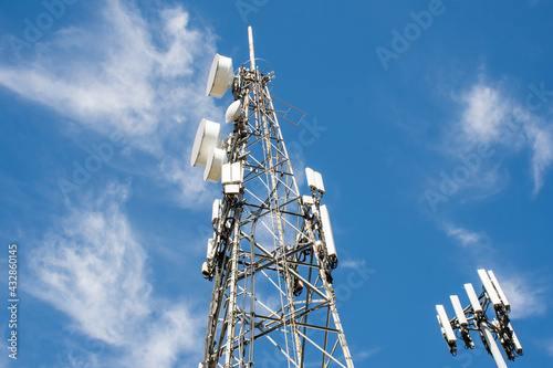 Radio, communication and cell towers on blue sky background