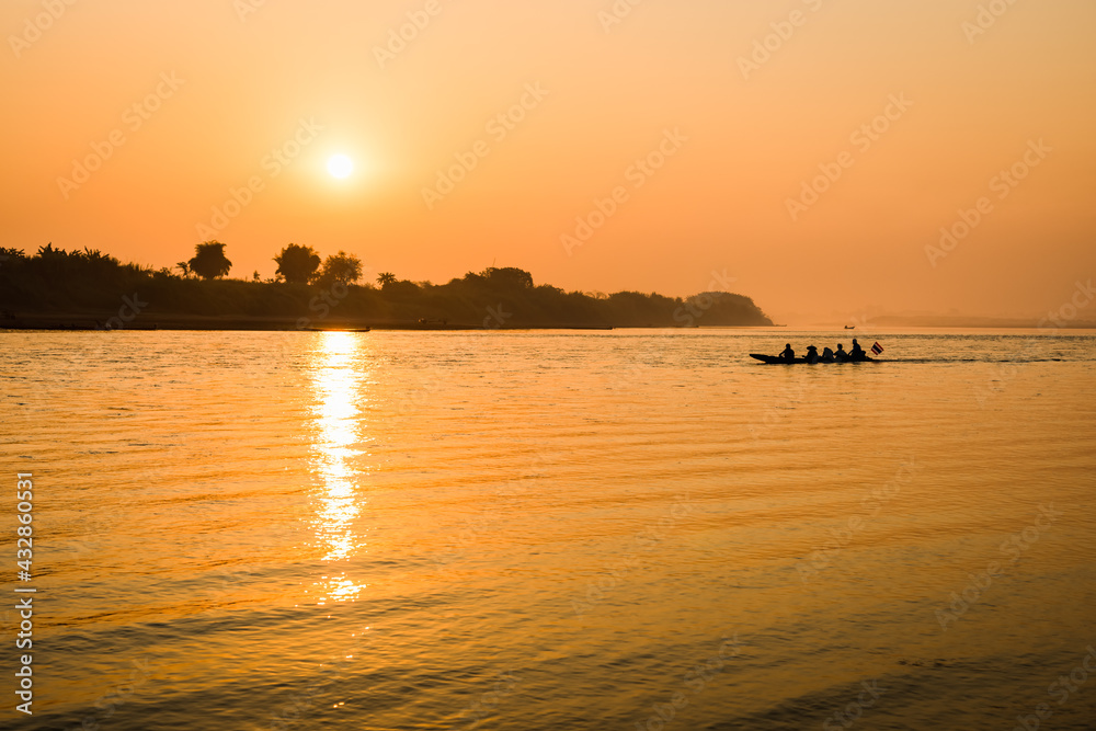 Fishermen in the boat on sunrise background Fishermen in the boat on sunrise background