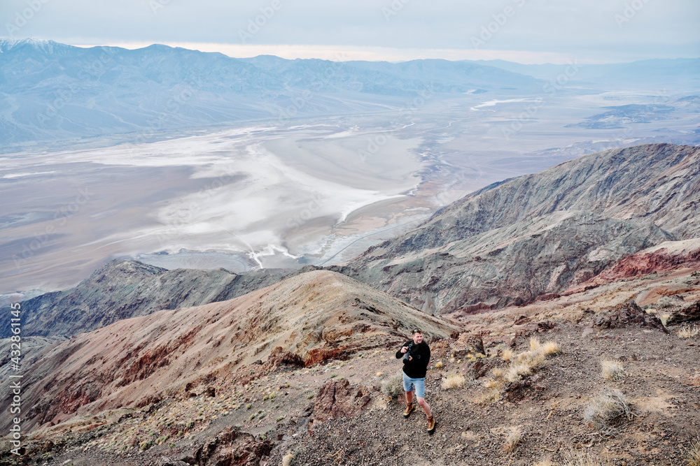 A family is hiking and enjoying the views in Death Valley national park in California, USA. It’s March 2021, the weather is warm and sunny. The views are stunning and the sand desert is spectacular.