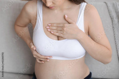 Fibrocystic Breast Disease. Closeup Shot Of Pregnant Woman Massaging Chest Area photo