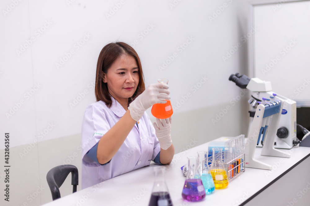 Young women researchers, doctors, scientists working with plastic medical tubes to examine scientific experiments in modern laboratories. Young women researchers, doctors, scientists working with plastic medical tubes to examine scientific experiments in modern laboratories.