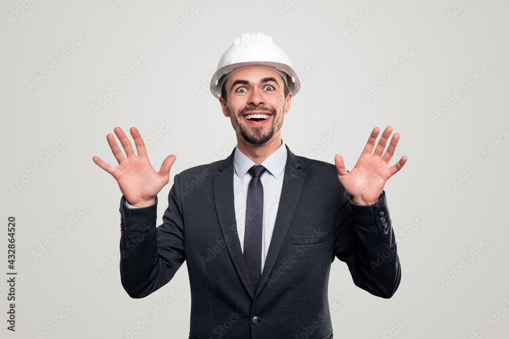 Excited engineer in hardhat and suit