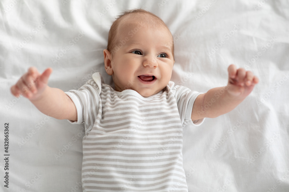 Infancy Concept. Closeup Portrait Of Cute Little Newborn Baby Relaxing In Bed Infancy Concept. Closeup Portrait Of Cute Little Newborn Baby Relaxing In Bed