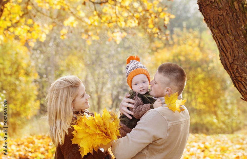 happy family with little baby in autumn park happy family with little baby in autumn park
