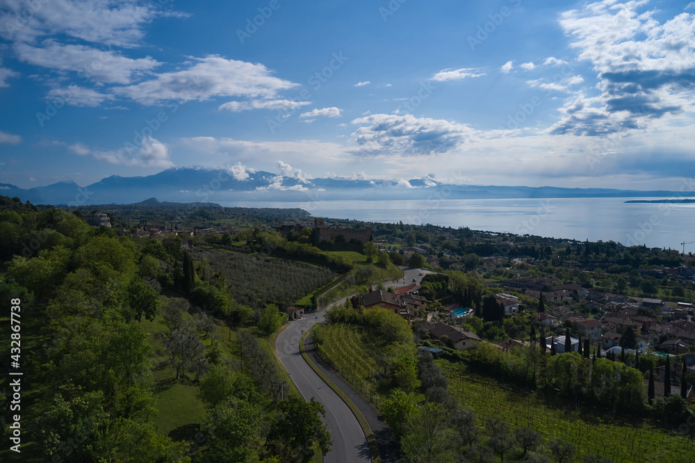 Aerial view of the historic part of Padenghe Castle on Lake Garda, Italy. Historic castles in Italy. Top view of the castle. Panorama of Lake Garda. Aerial view of the historic part of Padenghe Castle on Lake Garda, Italy. Historic castles in Italy. Top view of the castle. Panorama of Lake Garda.