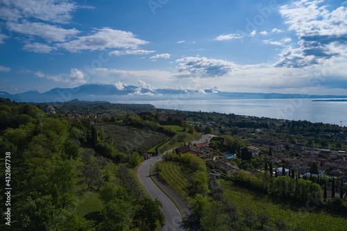 Fototapeta Naklejka Na Ścianę i Meble -  Aerial view of the historic part of Padenghe Castle on Lake Garda, Italy. Historic castles in Italy. Top view of the castle. Panorama of Lake Garda.
