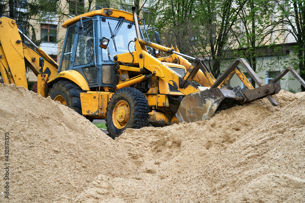 tractor or bulldozer works with a pile of sand for construction tractor or bulldozer works with a pile of sand for construction