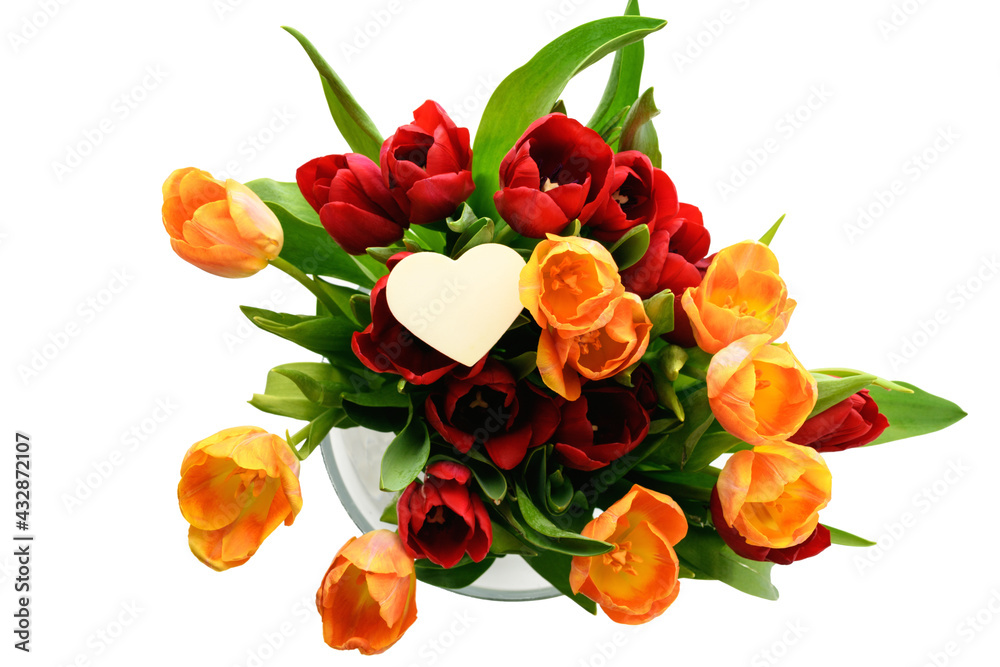 Bouquet of red and yellow tulips in a vase with a small heart isolated on white background. Spring and summer backdrop. Mother's day, Easter and seasonal holiday Bouquet of red and yellow tulips in a vase with a small heart isolated on white background. Spring and summer backdrop. Mother's day, Easter and seasonal holiday