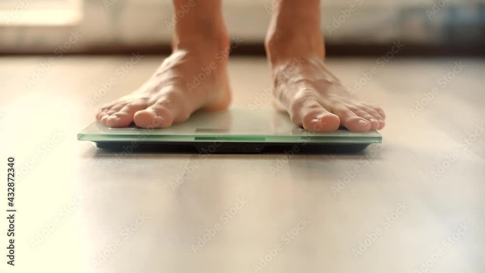 Man On Scales Measure Weight.Guy Legs Step On Bathroom Scale.Diet Man Feet Standing Weighing