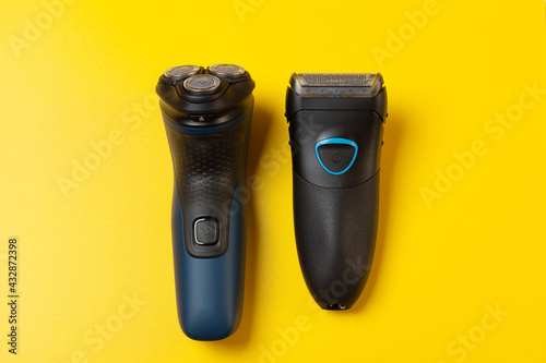 Foil and Rotary Electric Shavers on a yellow background photo