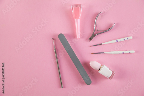 Manicure accessories on an isolated pink background.