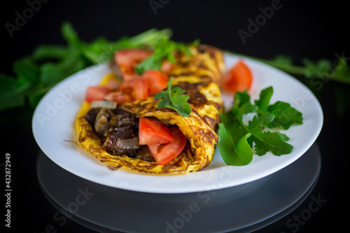 fried egg omelet with wild mushrooms and tomatoes