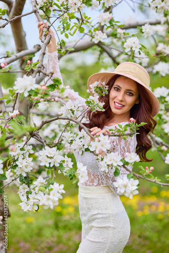 Beautiful natural woman in the garden of apple