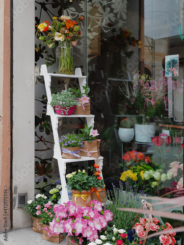 Plant and flower shop, detail. Shabby planter in the shape of a staircase outside the shop window.