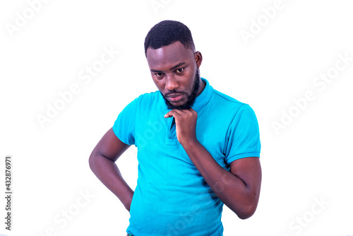 pensive young man crossing his hand under the chin.