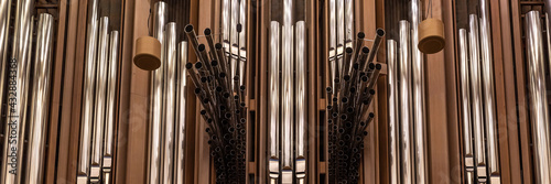 Fragment of organ at the Moscow House of Music, register with different pipes from metal, musical instrument, selected focus, banner for website