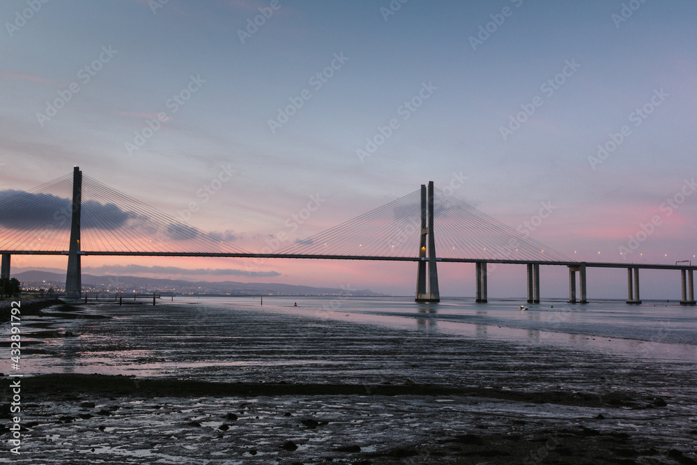Amazing view of  Vasco da Gama Bridge at sunset. The Vasco da Gama Bridge crosses the Tagus River and is one of the longest bridges in the world. Lisbon. Portugal.
