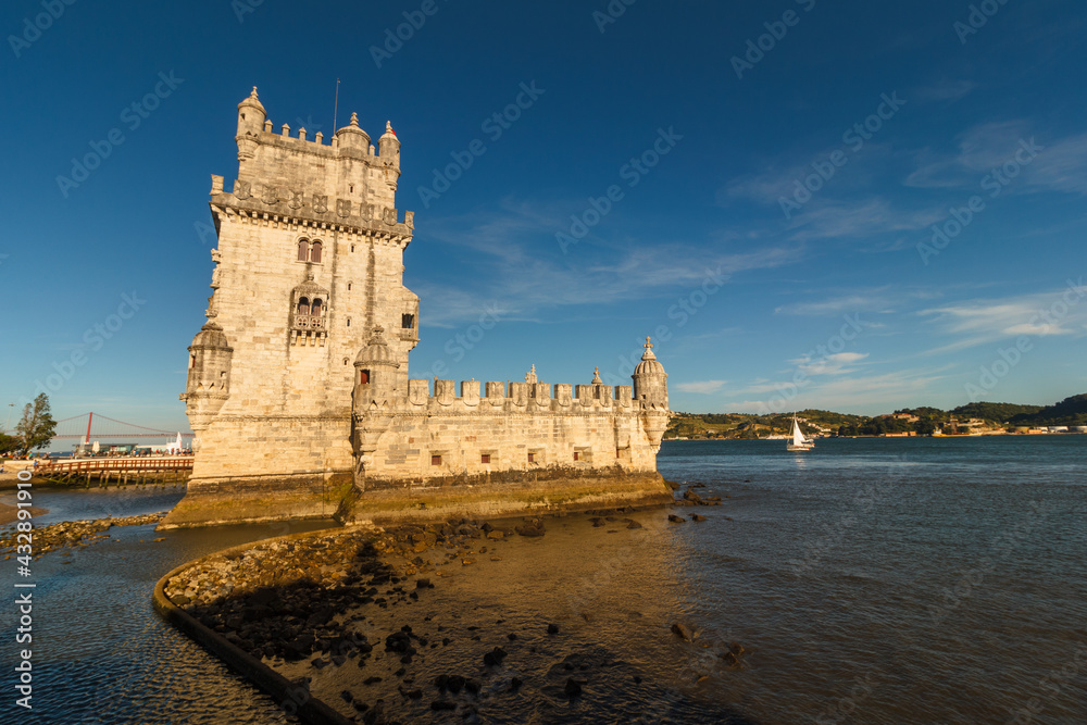 Belem Tower is a fortified tower on the Tagus river at sunset. Lisbon. Portugal. UNESCO World Heritage Site. Top tourist attraction in Europe. Concept of travel and tourism.