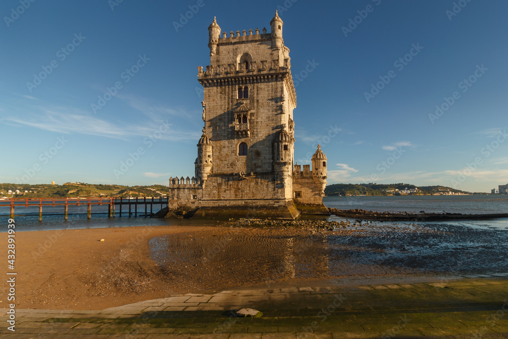 Belem Tower is a fortified tower on the Tagus river at sunset. Lisbon. Portugal. UNESCO World Heritage Site. Top tourist attraction in Europe. Concept of travel and tourism.