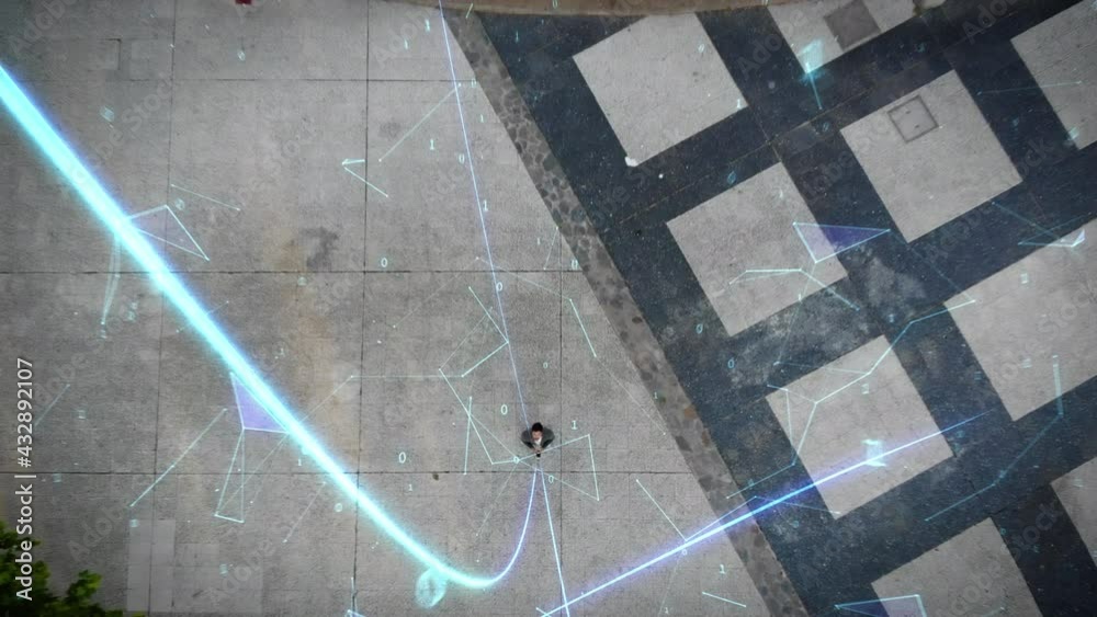 Overhead view of businessman using his smartphone on a big city full of traffic. Animation of bright lines representing concepts like Global Networks, Augmented Reality, Internet of Things. Drone shot