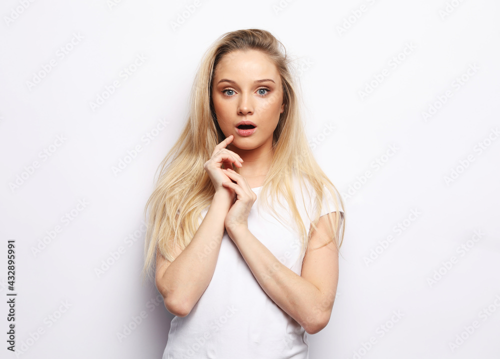 Shot of stupefied shocked blonde woman keeps mouth widely opened, looks at camera Shot of stupefied shocked blonde woman keeps mouth widely opened, looks at camera