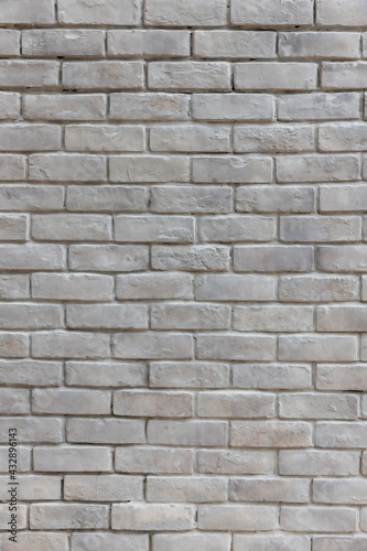 White brick wall background in rural room. Abstract weathered texture stained old stucco light gray. White grunge brick wall background. Misty brick wall for background or texture.