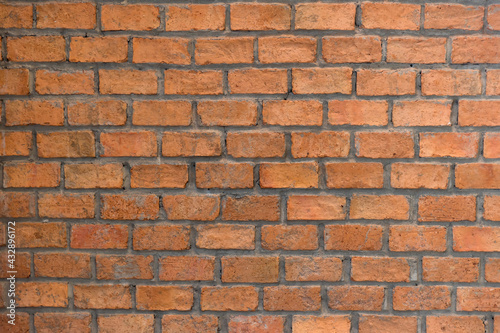 Red brick wall background in rural room. Abstract weathered texture stained old stucco light Red. Red grunge brick wall background. Misty brick wall for background or texture.