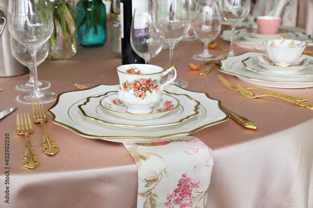 Close up of table set up for bridal shower, vintage tea set and floral napkins