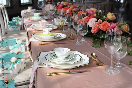 Wall Mural Table set up for bridal shower on bright summer day with flowers and vintage tea