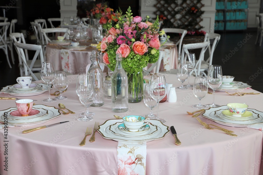 Close up of table set up for bridal shower, vintage tea set and floral napkins Close up of table set up for bridal shower, vintage tea set and floral napkins
