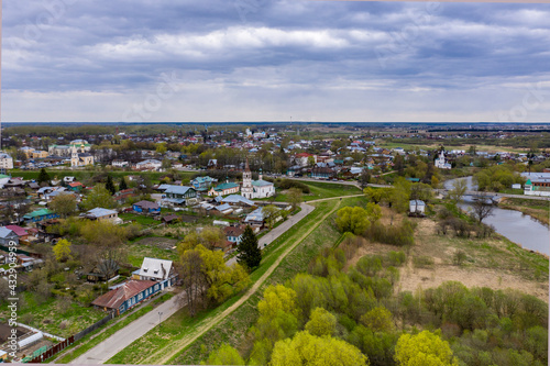 a panoramic view of the historical center of the temples and monasteries of the city of Suzdal in the rain filmed from a drone 