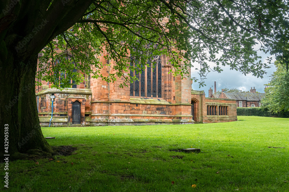 View of the cathedral from under a large tree in the city of Carlisle, Cumbria, UK