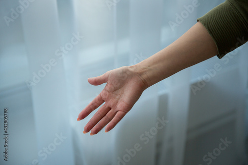 women's right hand with green jacket on white background