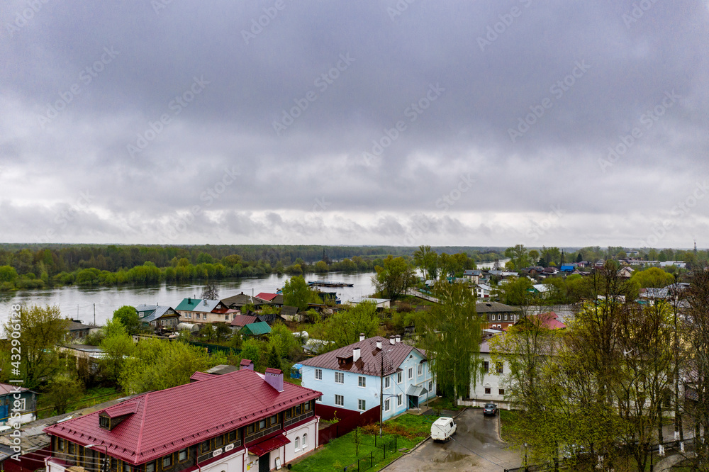 a panoramic view of the river and the historic center of Gorokhovets during the rain filmed from a drone 