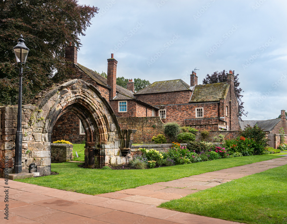 Carlisle Cathedral gardens and ancient archway in the city of Carlisle, Cumbria, UK