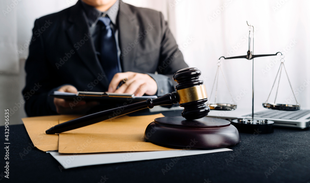 Business and lawyers discussing contract papers with brass scale on desk in office. Law, legal services, advice, justice and law concept Business and lawyers discussing contract papers with brass scale on desk in office. Law, legal services, advice, justice and law concept