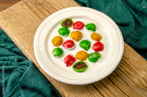 Badak Berendam is a popular dessert in Malaysia with sweet coconut inside and high demanded during the fasting month. Glutinous Rice Balls in Coconut Milk. photo