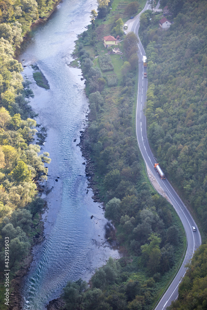 Highway along a mountain river top view.