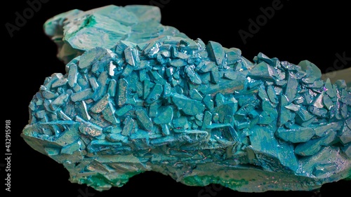 copper ammonium carbonate. blue crystals on a black background