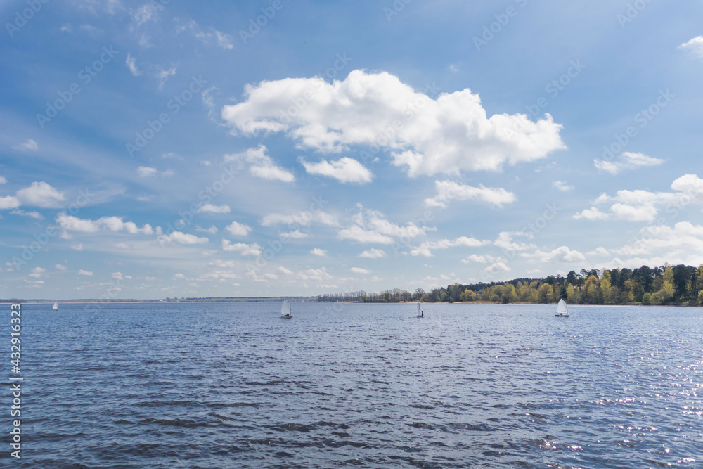Blue sky and lake with small sailing boats