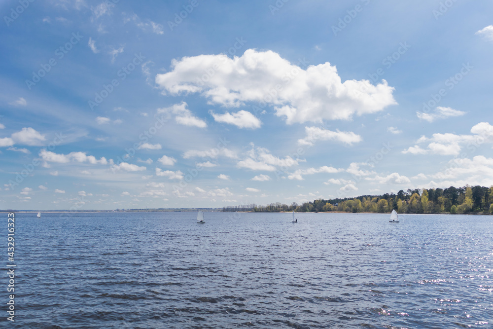 Blue sky and lake with small sailing boats Blue sky and lake with small sailing boats