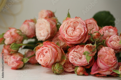 Beautiful bouquet of flowers pink roses on white wooden background