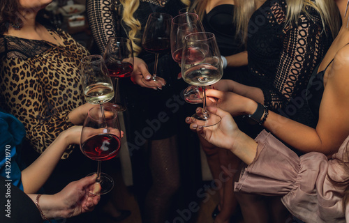 Clinking glasses with alcohol and toasting, party.