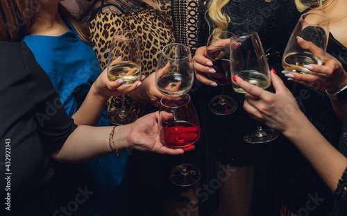 Clinking glasses with alcohol and toasting, party.