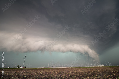 Εκτύπωση καμβά A severe thunderstorm and low shelf cloud loom over electrical equipment and power poles