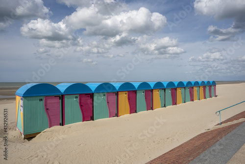 sandy beach and colorful bathhouse in Dunkirk, France