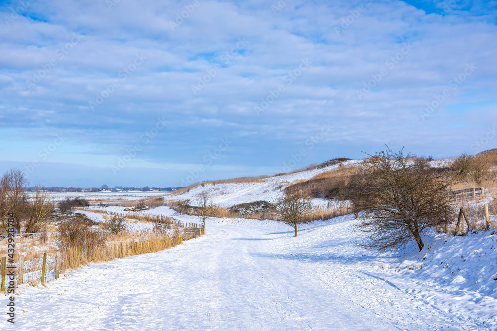 Snowy landscape with hills and meadows in Buytenpark Zoetermeer, the Netherlands Snowy landscape with hills and meadows in Buytenpark Zoetermeer, the Netherlands